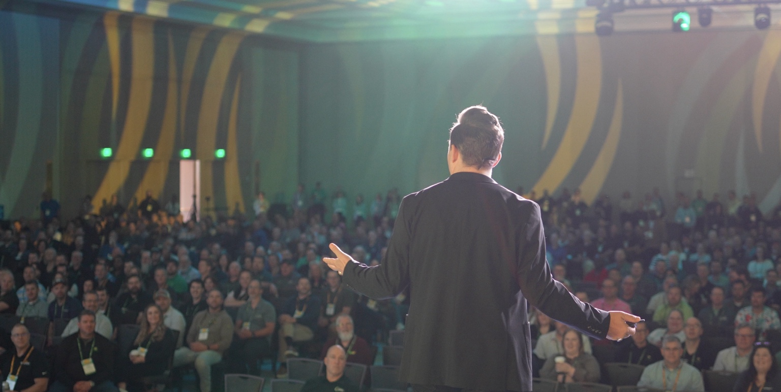 View from the stage as Frankie Russo speaks to a full conference audience