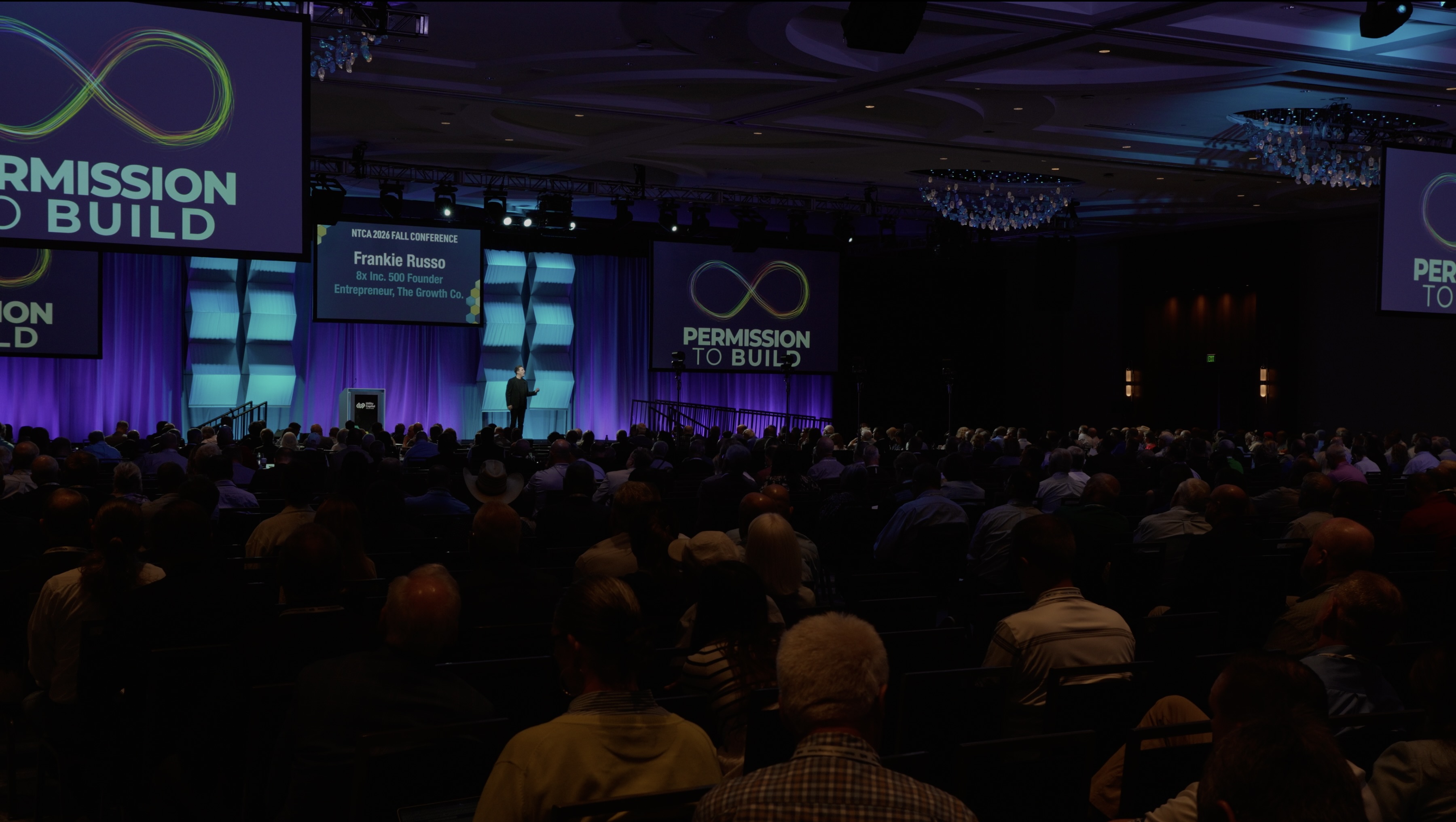 Frankie Russo presenting Permission to Build to a large conference audience